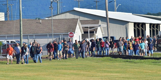 Employees evacuate the area following an incident Thursday, July 19, 2018, at Letterkenny Army Depot in Chambersburg, Pa..