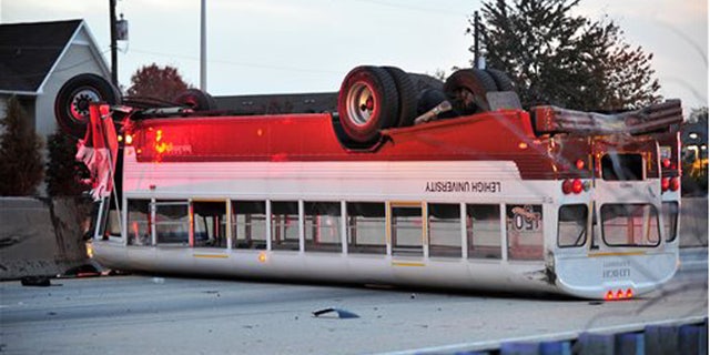 Oct. 27, 2015: A Lehigh University school bus remains on the scene following a fatal accident involving a car in Bethlehem, Pa.