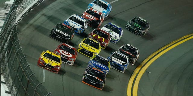 DAYTONA BEACH, FL - FEBRUARY 13: Denny Hamlin, driver of the #11 FedEx Express Toyota, and Joey Logano, driver of the #22 Shell Pennzoil Ford, lead a pack of cars during the NASCAR Sprint Cup Series Sprint Unlimited at Daytona International Speedway on February 13, 2016 in Daytona Beach, Florida. (Photo by Matt Sullivan/Getty Images)