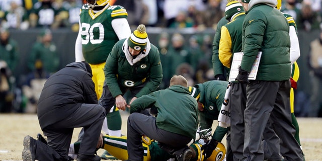 Jan. 5, 2014: Trainers check on Green Bay Packers cornerback Sam Shields (37) during the first half of an NFL wild-card playoff football game against the San Francisco 49ers in Green Bay, Wis.