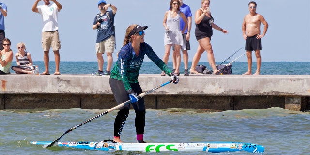 Victoria Burgess paddles the last few hundred feet to Key West, Fla., from Cuba on Wednesday. It took Burgess nearly 28 hours to make the approximately 100-mile voyage.