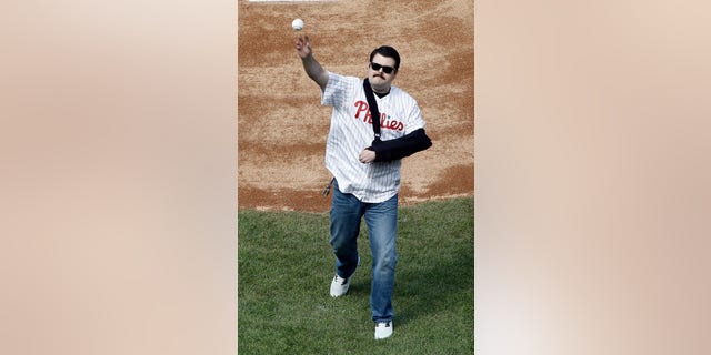 Philadelphia Police Officer Jesse Hartnett throws out a ceremonial first pitch before a Phillies game.