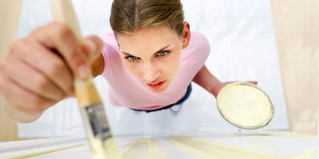 woman painting a door