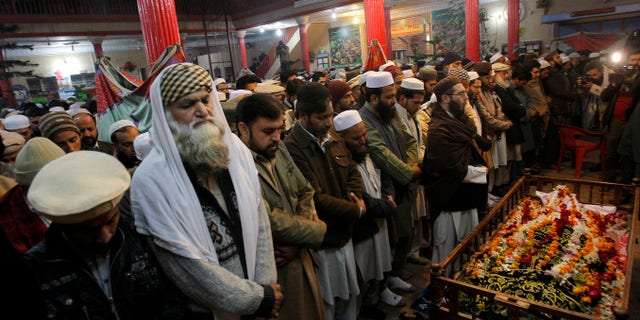 Dec. 16, 2014: Mourners and relatives of Pakistani teacher, Saeed Khan, a victim of a Taliban attack in a school, pray around his body, during his funeral procession in Peshawar, Pakistan.