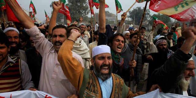 Nov. 23, 2013: Supporters of Tehreek-e-Insaf or Movement for Justice party chant anti-U.S. slogans during a rally in Peshawar, Pakistan. Thousands of people protesting U.S. drone strikes blocked a road in northwest Pakistan used to truck NATO troop supplies and equipment in and out of Afghanistan, the latest sign of rising tension caused by the attacks.