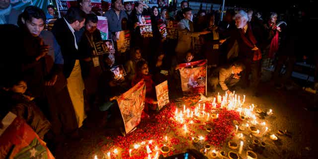 Jan. 16, 2015: Members of Pakistan's civil society groups light candles and shout anti-Taliban slogans to condemn the militant group's attack on a military-run school in Peshawar.
