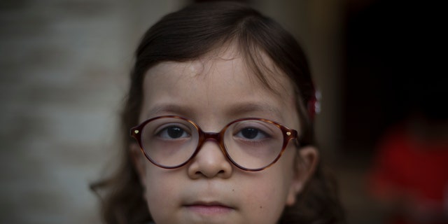 Pakistan's Maria, 6, who is suffering from MPS, poses for a picture in Rawalpindi, Pakistan.