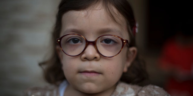 Pakistan's Maria, 6, who is suffering from MPS, poses for a picture in Rawalpindi, Pakistan.