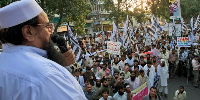 Sept. 30, 2012: Hafiz Saeed, leader of Pakistani religious group Jamaat-ud-Dawa, left, delivers a speech during a protest against a film insulting the Prophet Muhammad, in Lahore, Pakistan.
