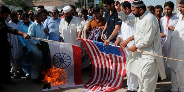 Sept. 23: Pakistani protesters burn representations of US and Indian flags at an anti-American rally in Multan, Pakistan. Pakistan lashed out at the U.S. for accusing the country's most powerful intelligence agency of supporting extremist attacks against American targets in Afghanistan - the most serious allegations against Islamabad since the beginning of the Afghan war.