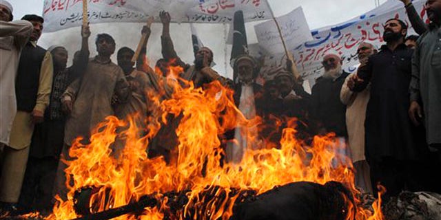 Dec. 1, 2011: Pakistani protesters burn an effigy of President Obama during a protest to condemn killings of Pakistani troops in NATO airstrikes, in Peshawar, Pakistan.