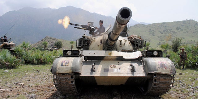 July 10: A Pakistani army soldier fires toward a target at a forward base during a military operation against militants in Pakistan's Khurram tribal region. A military operation in Kurram tribal region has been launched to clear the area of terrorists involved in various terrorist activities, including kidnapping and killing of locals, suicide attacks and blocking the road connecting lower with upper Kurram, Pakistani army spokesman Maj. Gen. Athar Abbas said.
