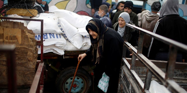 A Palestinian refugee leaves a United Nations food distribution center after receiving aid in Al-Shati refugee camp in Gaza City in January.