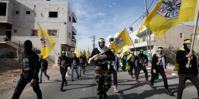 Masked men take part in the funeral of Palestinian youth Qusai Al-Amour, who Israeli and Palestinian officials said was shot dead by Israeli border police during a clash with protesters on Monday, in the West Bank village of Tuqu near Bethlehem January 17, 2017. REUTERS/Mussa Qawasma - RTSVWGC