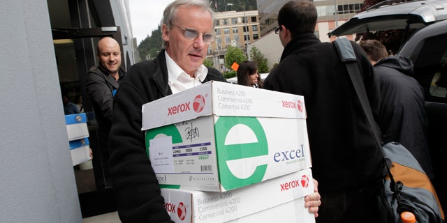 June 10: A reporter carries boxes containing thousands of pages of Sarah Palin's emails from her time as Alaska's governor in Juneau, Alaska.