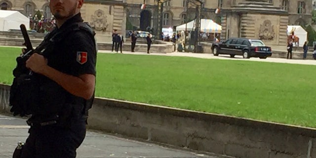 President Trump's armored vehicle ("The Beast") enters Les Invalides complex.