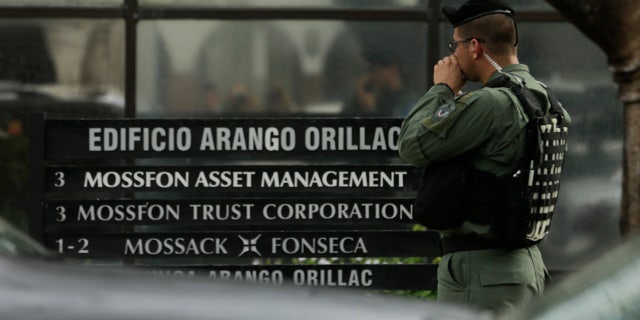 April 12, 2016: A police officer stands outside the Mossack Fonseca law firm while organized crime prosecutors raid its offices in Panama City