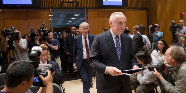 New York City police commissioner William Bratton enter a news conference Wednesday, June 4, 2014.