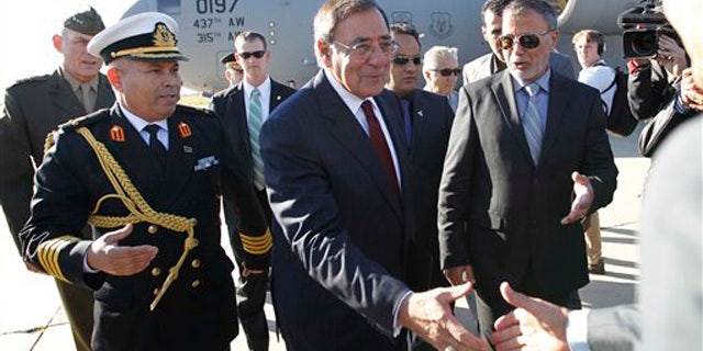 Dec. 17, 2011: Defense Secretary Leon Panetta greets officials in Tripoli, Libya.