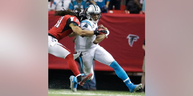 Falcons linebacker Philip Wheeler hits Panthers quarterback Cam Newton during the second half of a football game.