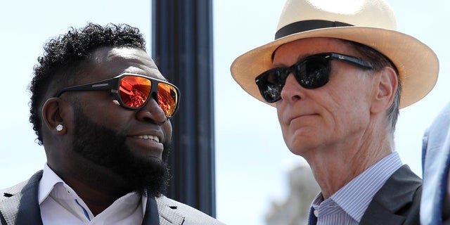 Boston Red Sox owner John Henry, right, said he would consider renaming the street for retired player David Ortiz, left.