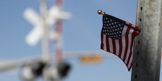 Nov. 17, 2012: A flag is left at the scene of an accident where four veterans were killed and 16 other people were injured when a train slammed into a parade float carrying the returning heroes to a banquet last Thursday in Midland, Texas.