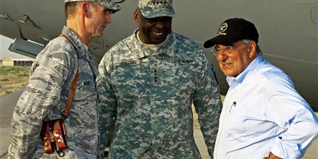 US Secretary of Defense Leon Panetta, right, has a brief chat with his US Generals Anthony Rock, left, and Lloyd Austin, late Sunday July 10, 2011, during an unannounced visit by the U.S. Secretary to Camp Dwyer, Sunday July 10, 2011, in southern Afghanistan. (AP Photo/Paul J. Richards, Pool)