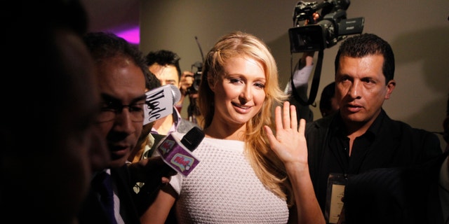 U.S. socialite Paris Hilton waves after a news conference during the launch of her latest store in Bogota, April 24, 2013.