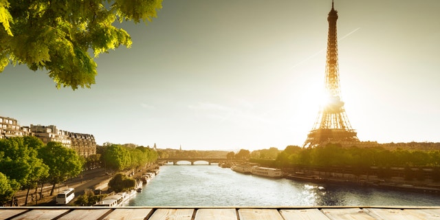 background with wooden deck table and Eiffel tower in Paris
