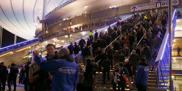 Crowds leave the Stade de France where explosions were reported to have detonated outside the stadium during the France vs German friendly match near Paris, Nov. 13, 2015. (REUTERS/Gonazlo Fuentes)
