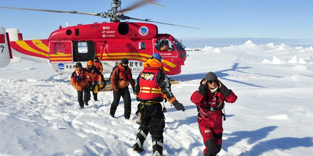 Jan. 2, 2014: In this photo provided by China's Xinhua News Agency, the first group of passengers who were aboard the trapped Russian vessel MV Akademik Shokalskiy arrive at a safe surface off the Antarctic.