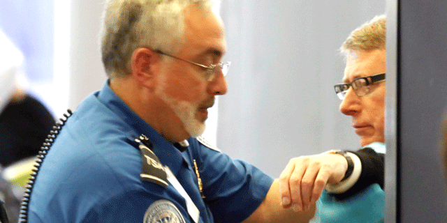 Nov. 17: An airline passenger is patted down by a TSA agent at O'Hare International Airport in Chicago.