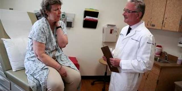 April 28, 2015: Patient Carole Linderman speaks to Dr. Massimo Cristofanilli before her blood is drawn for a liquid biopsy at Jefferson University Hospital in Philadelphia.