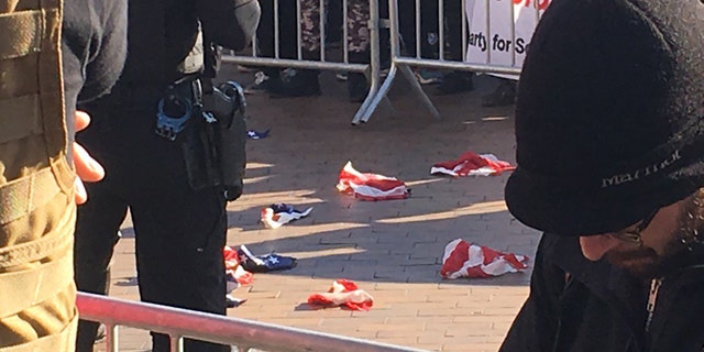 Torn pieces of an American flag lie on the ground at the University of Washington, Feb. 10, 2018.
