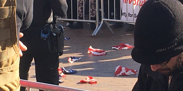 Torn pieces of an American flag lie on the ground at the University of Washington, Feb. 10, 2018.