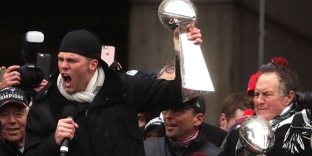 BOSTON - FEBRUARY 7: New England Patriots quarterback Tom Brady and New England Patriots head coach Bill Belichick hoist the Lombardi Championship trophies during the rally at City Hall Plaza in Boston on Feb. 7, 2017. The rally was after the New England Patriots Super Bowl LI Victory Parade. (Photo by Barry Chin/The Boston Globe via Getty Images)
