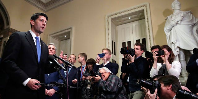 House Speaker Paul Ryan of Wis., left, speaks during a news conference after the House voted to approve the Republican tax bill, Tuesday, Dec. 19, 2017, on Capitol Hill in Washington.