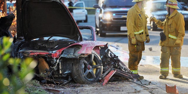 November 30, 2013. Sheriff''s deputies work near the wreckage of a Porsche that crashed into a light pole on Hercules Street near Kelly Johnson Parkway in Valencia, Calif.. A publicist for actor Paul Walker says the star died in the crash north of Los Angeles.