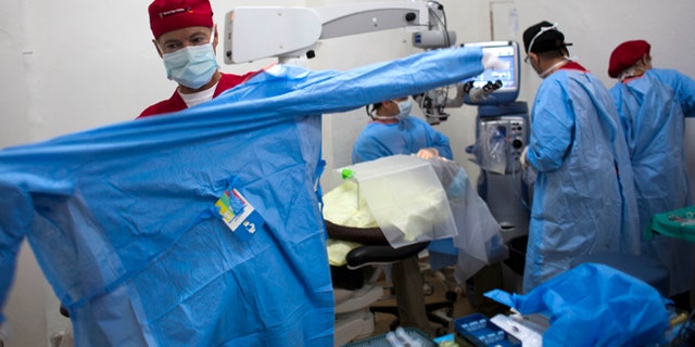 Aug. 17, 2015: Republican presidential candidate, Sen. Rand Paul, R-Ky. puts on scrubs to perform cataract surgeries in Cap-Haitien, Haiti. (AP)