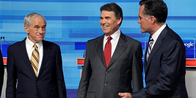 Sept. 22: Republican presidential candidates Rep. Ron Paul, Texas Gov. Rick Perry and former Massachusetts Gov. Mitt Romney greet each other prior to the Fox News/Google debate in Orlando, Fla.