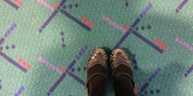 Jan. 23, 2015: This selfie taken by Julie Sabatier, at Portland International Airport in Portland, Ore., shows her feet on older carpet due to be replaced at the terminal.