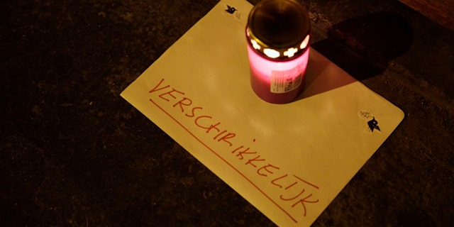 Dec. 12: A lone candle with a note reading "horrible" sits in the doorway of a daycare center in Amsterdam, where a man suspected of abusing preschool children was employed. Parents of dozens of preschool children in Amsterdam have been warned their children may have been abused by a baby sitter in one of the worst sexual abuse cases to come to light in the Netherlands. (AP)