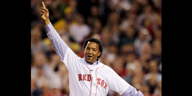 FILE - In this April 4, 2010, file photo, former Boston Red Sox pitcher Pedro Martinez reacts after throwing the ceremonial first pitch before the Red Sox opening game of the baseball season against the New York Yankees in Boston. Martinez, a three-time Cy Young Award winner and eight-time All-Star, who spent seven seasons in Boston, was brought back to the franchise to serve as a special assistant to general manager Ben Cherington, the team announced, Thursday, Jan. 24, 2013. (AP Photo/Charles Krupa, File)