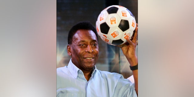 FILE - In this Oct. 12, 2015 file photo, Brazilian football legend Pele poses with a football during an interaction session with students in Kolkata, India. (AP Photo/Bikas Das File)