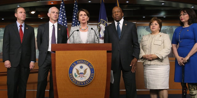 WASHINGTON, DC - MAY 21: Minority Leader Nancy Pelosi (D-CA) (C) speaks while flanked by five fellow Democrats (L-R) Rep. Rep. Adam B. Schiff (D-CA), Rep. Adam Smith (D-WA), Rep. Elijah E. Cummings (D-MD), Rep. Linda Sanchez, (D-CA) and Rep. Tammy Duckworth (D-IL) during a news conference on Capitol Hill, May 21, 2014 in Washington, DC. Leader Pelosi named the five Democrats to serve on the special committee looking into the 2012 attack in Benghazi, Libya. (Photo by Mark Wilson/Getty Images,)