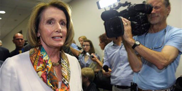 House Minority Leader Nancy Pelosi walks past reporters as she heads to a Democratic caucus meeting on Capitol Hill in Washington Aug. 1.