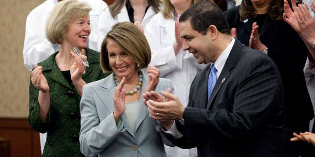 Rep. Tammy Baldwin, D-Wisc., Democratic Minority Leader, Nancy Pelosi, D-Calif., and Rep. Henry Cuellar, D-Tex., at a ceremony marking the one year anniversary of the passage of the Health Care Act on Capitol Hill in Washington on Thursday, March 17, 2011. (AP)
