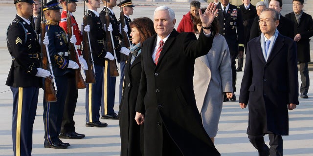 Vice President Mike Pence waves upon his arrival at Osan Air Base in Pyeongtaek, South Korea, Feb. 8, 2018.