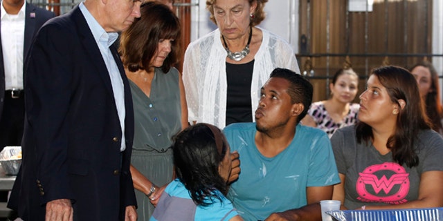 U.S. Vice President Mike Pence, left, and his wife Karen Pence, second left, meet with Venezuelans at the Calvary Chapel in Cartagena, Colombia, Monday, Aug. 14, 2017. Pence is seeking to highlight the growing plight of Venezuelans with a visit with people who've fled the country to neighboring Colombia. He prayed with faith leaders and Venezuelan families before departing to Buenos Aires, Argentina later Monday. (AP Photo/Fernando Vergara)