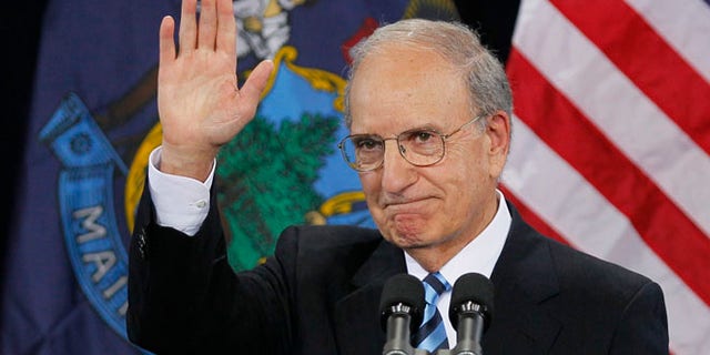 In this March 30, 2012 file photo, former Senate Majority Leader George Mitchell acknowledges the crowd after speaking at a campaign stop for President Obama at Southern Maine Community College in South Portland, Maine.